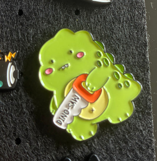 Dino-saw pin badge