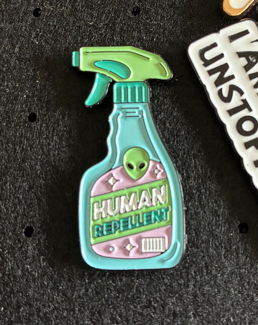 Human repellent pin badge